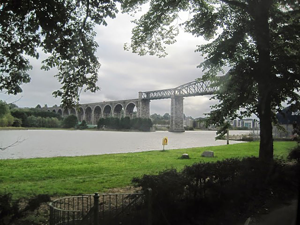 Image of a tall rail bridge over water.